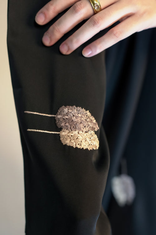 Close up of rose gold leaf embroidery on IMAN APPAREL Black Abaya